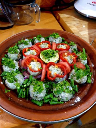 a plate of food with tomatoes and other vegetables at Maison d'hôtes IZZA in Kalaat MGouna
