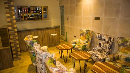 a room with couches and tables in a bar at TN MAX LUXURY HOME in Enugu