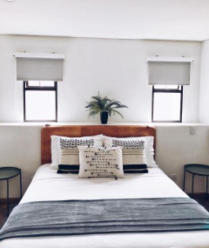 a bedroom with a large white bed with pillows at 574 Hotel in Medellín
