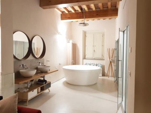 a bathroom with two sinks and a large tub at Luxury Tower House in heart of Pisa in Pisa
