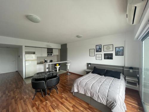 a bedroom with a bed and a table and a kitchen at Metropolitan Highline Apartments in Buenos Aires