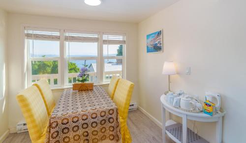 a dining room with a table and chairs and a window at Sunrise on Lake Washington in Seattle