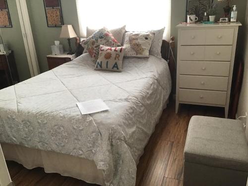 a bedroom with a bed with pillows and a dresser at Clovis, CA National Parks Room in Clovis
