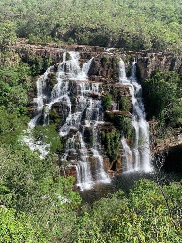 an aerial view of a waterfall in a forest at Pousada Estrela Veadeiros in Alto Paraíso de Goiás