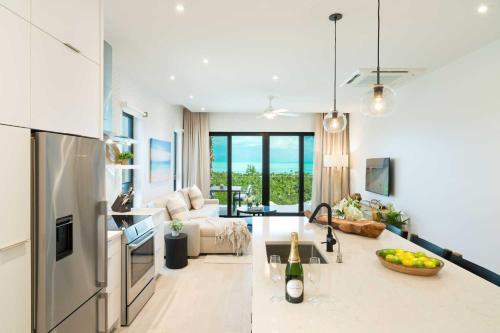 a kitchen and a living room with a counter top at H2O LifeStyle Resort in Long Bay Hills