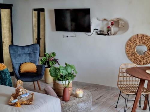 a living room with a blue chair and a table at Mare è rocca in Bonifacio