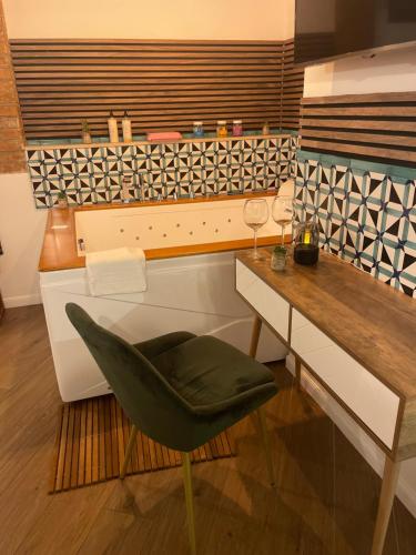 a living room with a desk and a green chair at B&B Vietri Centro in Vietri