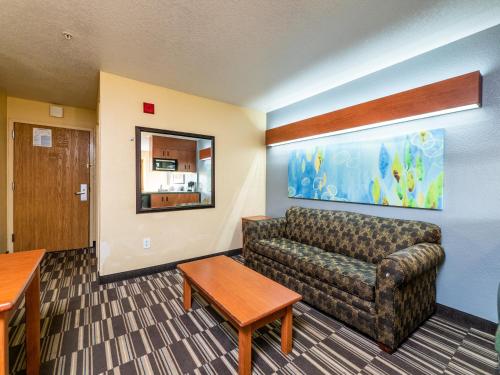 a living room with a couch and a table at Microtel Inn and Suites Ocala in Ocala