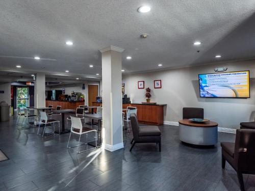 a waiting room at a hospital with tables and chairs at Microtel Inn and Suites Ocala in Ocala
