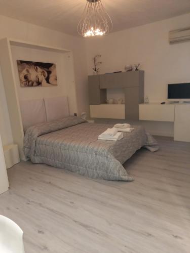 a bedroom with a bed and a chandelier at Casanova Apartment in Venice