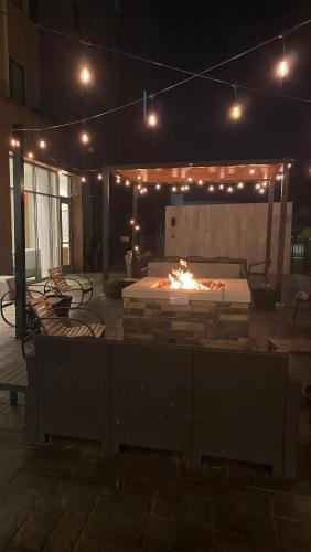 a patio with a fire pit at night at Staybridge Suites - Cincinnati East - Milford by IHG in Cincinnati