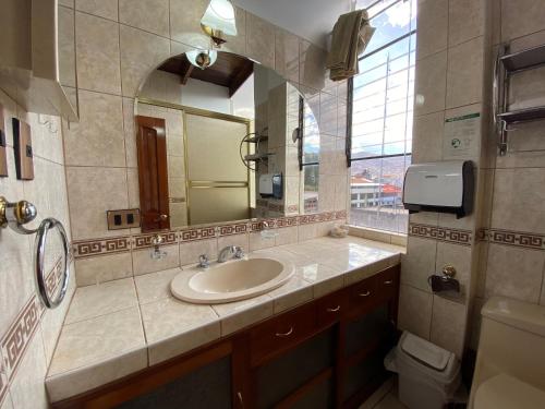 a bathroom with a sink and a mirror at Cusco Golden Perú Inn in Cusco