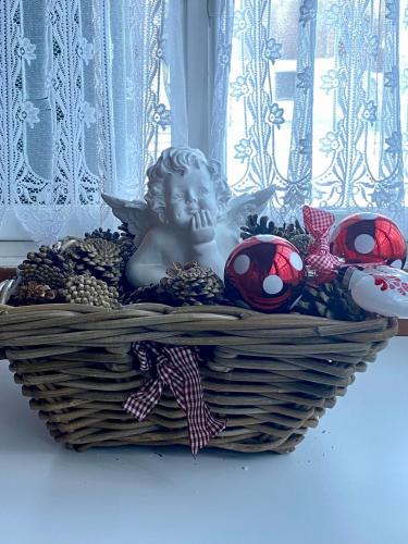 a basket with a little angel sitting in it at Familienferien im Chalet Bärgli Kandersteg in Kandersteg