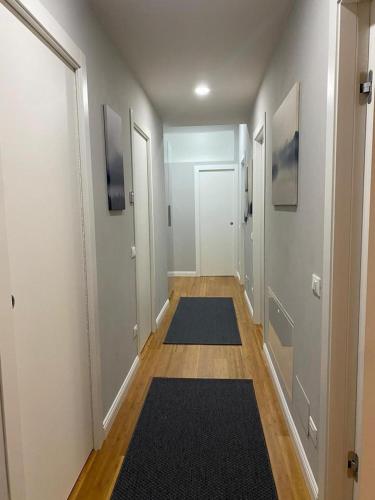an empty hallway with rugs on the floors and doors at Casa Linda in Pavia