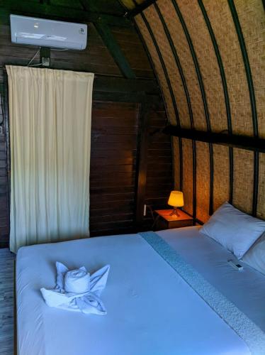 a bedroom with a bed with a blue light at Gili Davidoff Bungalow in Gili Trawangan