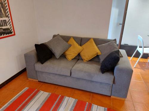 a couch with pillows on it in a living room at A Casa de São Pedro de Moel in São Pedro de Moel