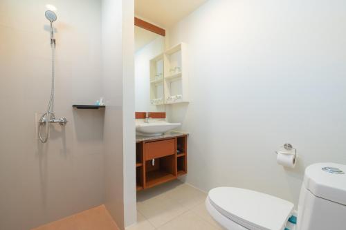 a bathroom with a toilet and a sink at Hill Myna Holiday Park & Cafe in Bang Tao Beach