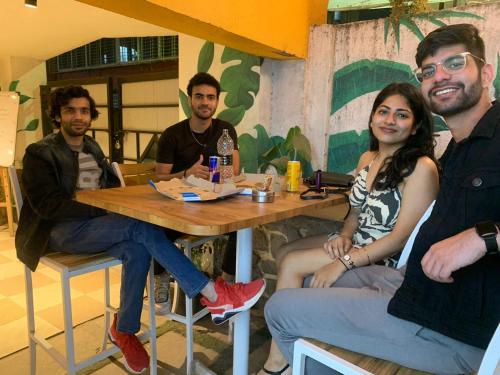 a group of people sitting at a table in a restaurant at Coliwo Un - Viman Nagar in Pune