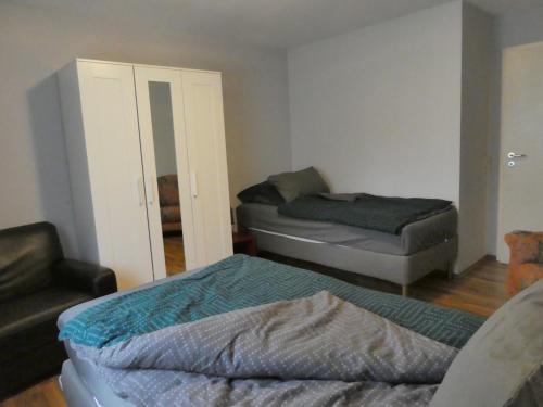 a living room with two beds and a chair at Ferienwohnung Wanderparadies Neuwied-Heimbach in Neuwied