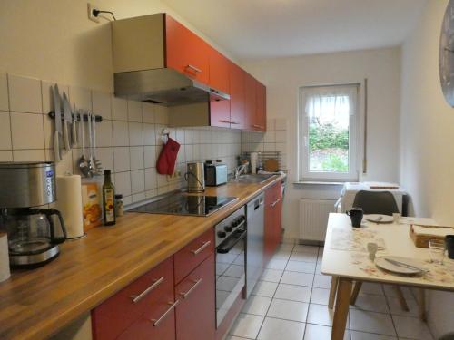a kitchen with red cabinets and a counter top at Ferienwohnung Wanderparadies Neuwied-Heimbach in Neuwied