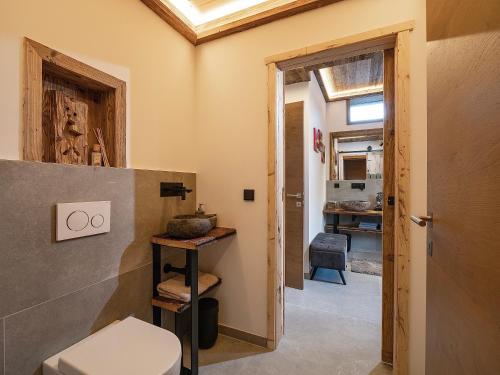 a bathroom with a toilet and a sink at das brunn - Luxus Chalet in Kirchberg in Tirol