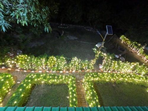 an overhead view of a garden with christmas lights at CAMP BIG CAT CORBETT, Hotel Resort booking, Dhikuli, Near Kosi River, garjiya Bijrani Sitabani Safari ZonesJim Corbett Park, Ramnagar in Garjia