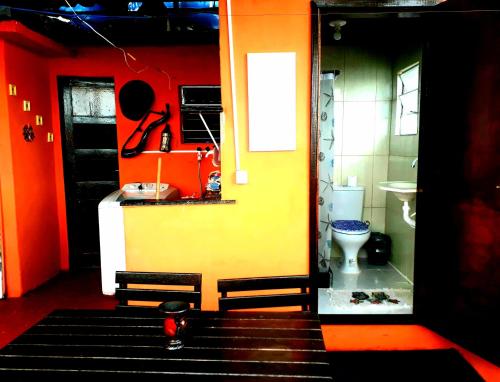 an orange and yellow bathroom with a toilet at Hostel Tavares Bastos in Rio de Janeiro