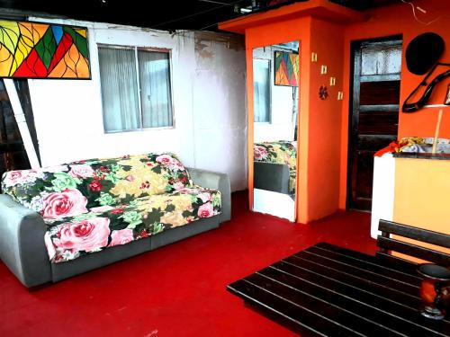 a living room with a couch and some windows at Hostel Tavares Bastos in Rio de Janeiro