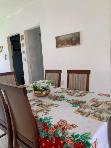 a dining room table with a table cloth with flowers on it at Casa alto da Boa Vista in Maragogi