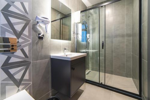 a bathroom with a sink and a shower at Sirius Otel İstanbul in Istanbul