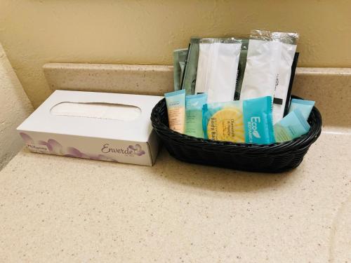 a basket of toiletries and a box on a counter at Honeysuckle Inn in Mountain View