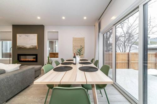 a dining room with a table and a couch at Chic Hideaway, 5BR near DT, Fireplace, King Bed, Fast Wifi, Sleeps 13! in Edmonton