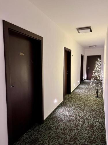 a hallway with a christmas tree in the middle at Hotel & Restaurant Pod Kaštany in Krupka - Marsov