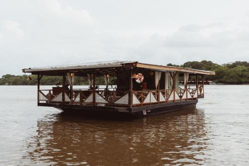a boat in the water on a river at Mawamba Lodge in Tortuguero