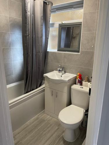 a bathroom with a toilet and a sink at Entire Lovely 2 bedroom apartment with private garden & free street parking in London