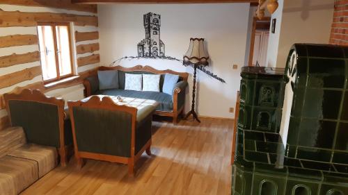a bedroom with a bed and a couch in a room at Chata U Vlastíka in Malá Morávka