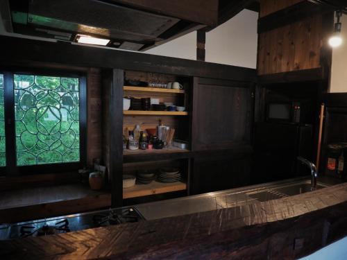 a kitchen with a sink and a window in it at Kominka Washinkan - Vacation STAY 13791 in Yaita