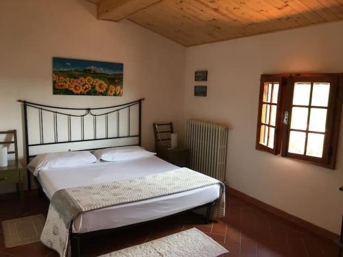 a bedroom with a bed in a room with a window at Podere La Cerraia in Serravalle Pistoiese