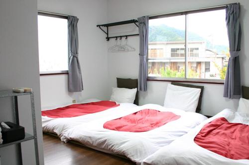 two beds in a room with two windows at RETRO retro - Vacation STAY 96287v in Azagawa