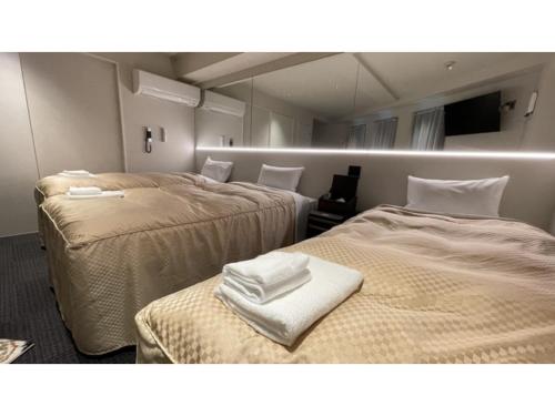 a room with two beds with white towels on them at Hotel Wisteria NARA - Vacation STAY 99258v in Nara