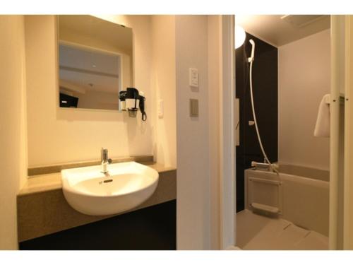 a bathroom with a white sink and a shower at Hotel Wisteria NARA - Vacation STAY 99258v in Nara