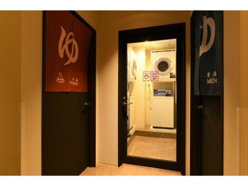 a room with a door with a mirror and a refrigerator at Hotel Wisteria NARA - Vacation STAY 99245v in Nara