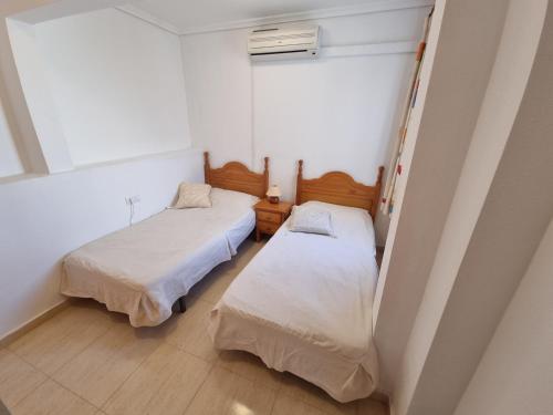 Cette petite chambre comprend 2 lits et une fenêtre. dans l'établissement Monte Mar Apartment, à Gran Alacant