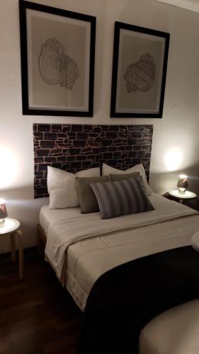 a bedroom with a large bed and a brick wall at Pacific Spot San Miguel in Lima