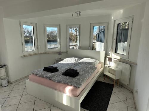 a bedroom with a bed with two black towels on it at Apartment Donaublick in Bad Abbach