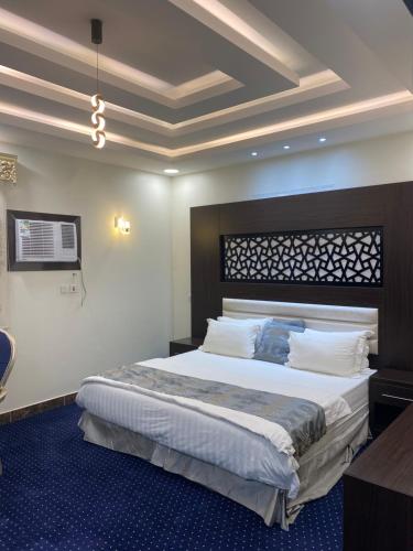 1 dormitorio con 1 cama grande en una habitación en إعمار الشرفةللشقق المفروشه en Najrán