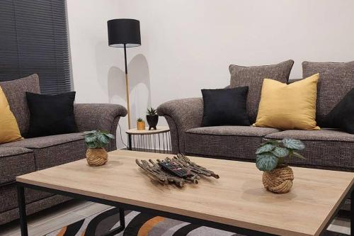 a living room with two couches and a coffee table at Overnight stay. Self-catering. in Klerksdorp