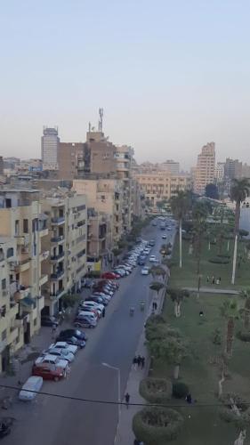 a city street with cars parked in a parking lot at وسط البلد عابدين in Cairo