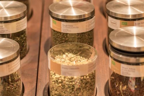a group of jars filled with seeds on a shelf at Hotel Sportalmmm, Hoch-Genuss in Zauchensee