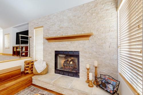 a fireplace in a living room with a brick wall at Hidden Creek Retreat in Park City